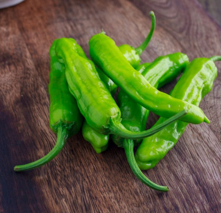 Close up of ripe, bright green shishito peppers