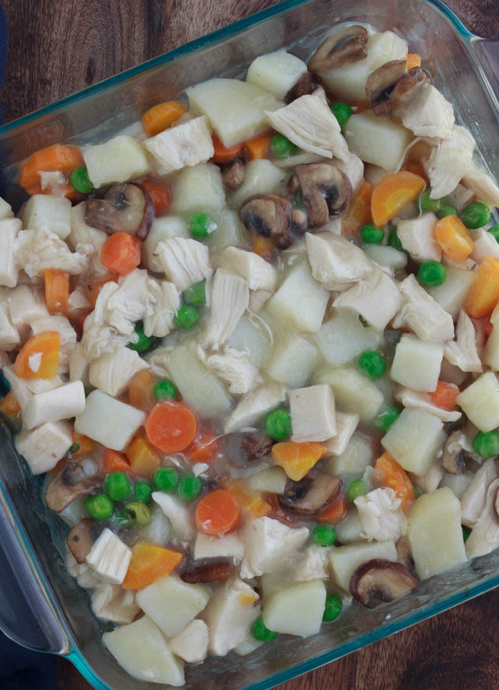 Chicken pot pie filling in a baking dish