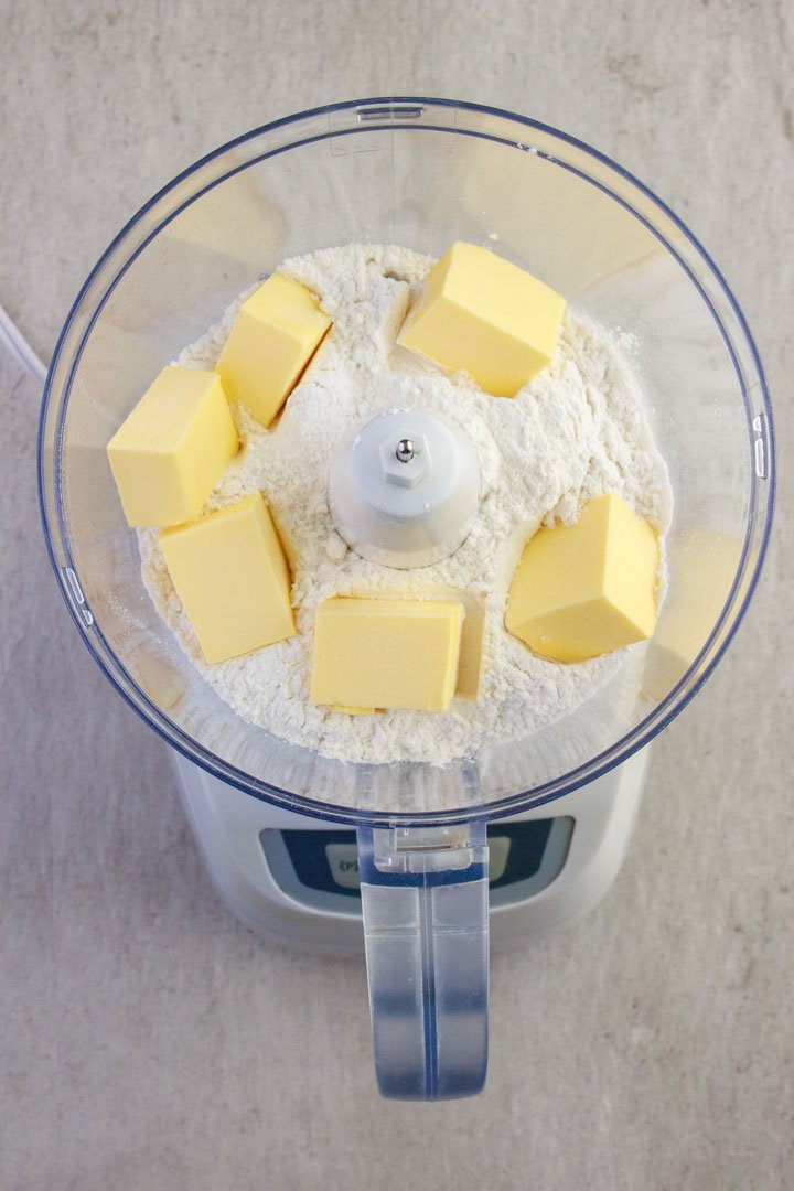 Gluten-free flour blend and butter in a food processor