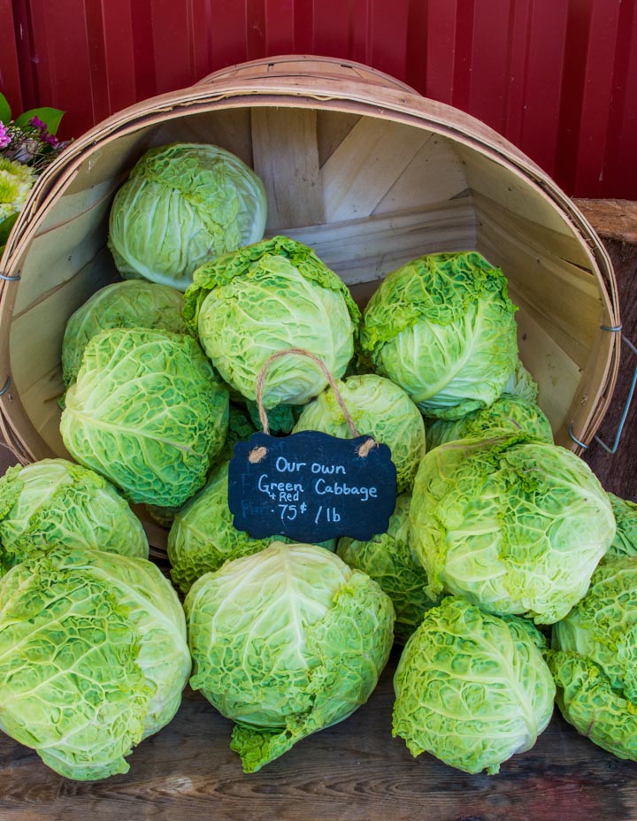 Farmers setting the price of their produce at the market. Photo of cabbage for 75 cents a pound.