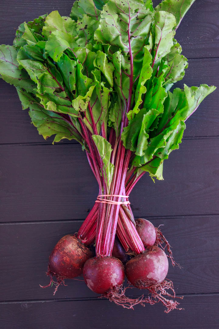 Bundle of fresh beets from the farmers market with the beet greens attached