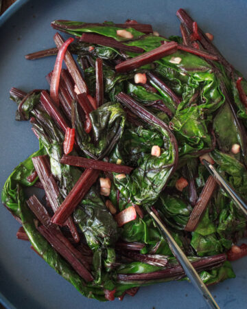 Sautéed beet greens with garlic and onion, on plate and ready to be served