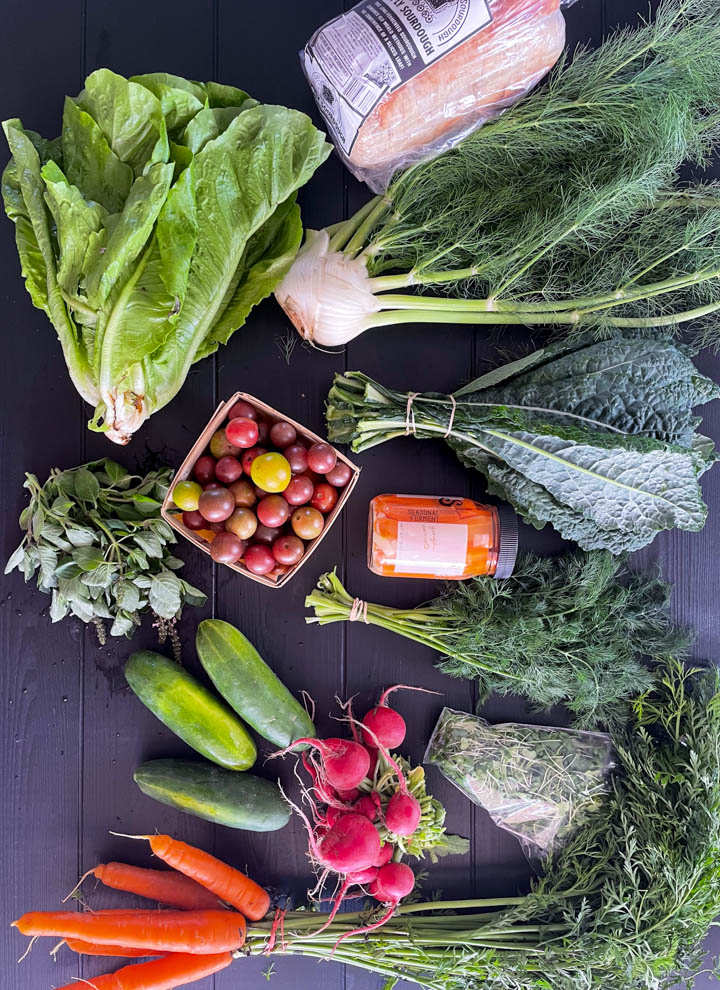 Photo of things I buy at the farmers market: cucumber, kale, fennel, lettuce, carrots, radish and more.
