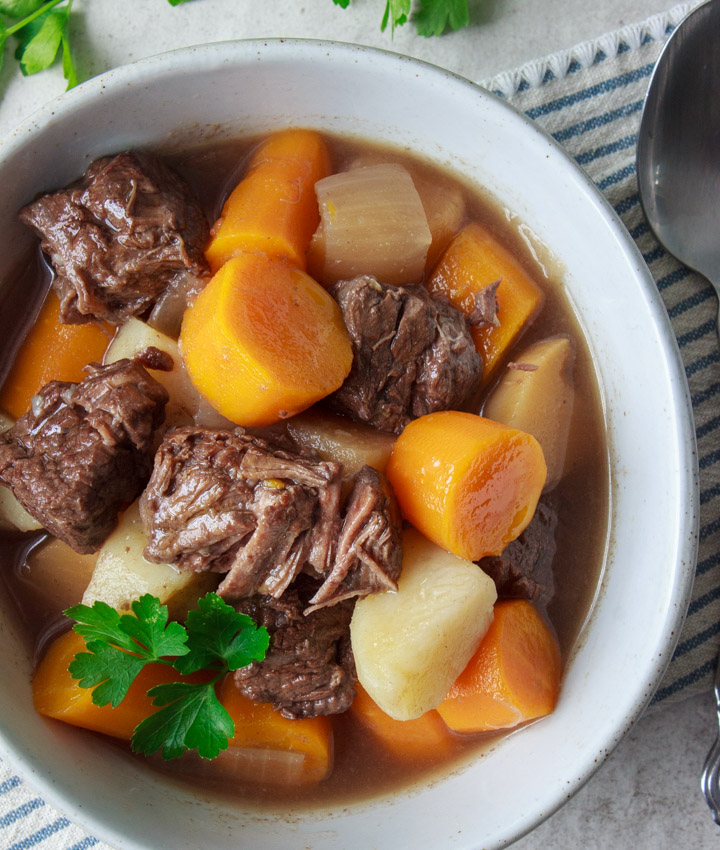 Gluten-free beef stew in a bowl with a spoon