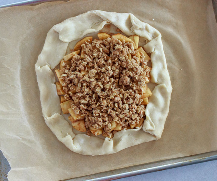 Folding in the edges of an apple galette