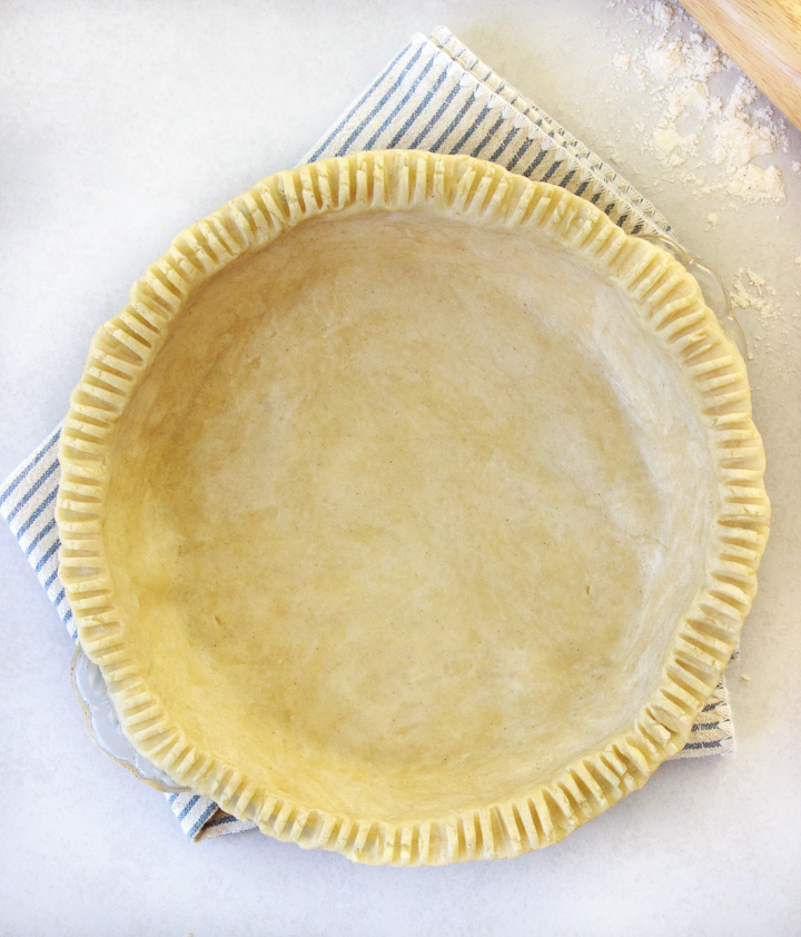 Gluten-free pie crust in a pie plate ready for the oven