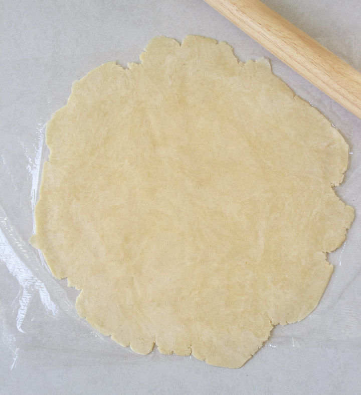 Gluten free pie crust rolled out with a rolling pin