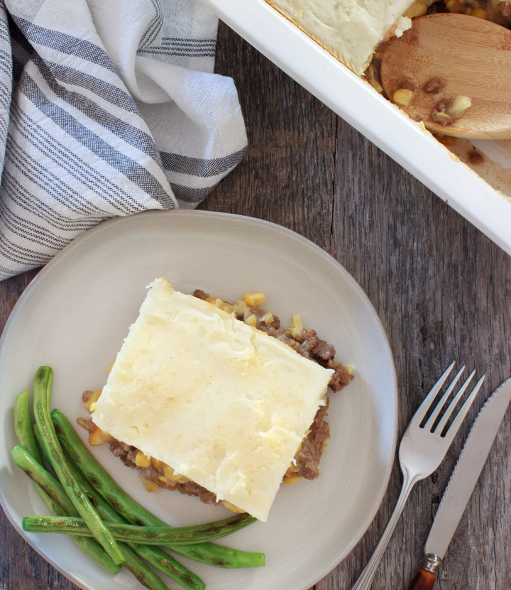 Shepherd's Pie on a plate with green beans