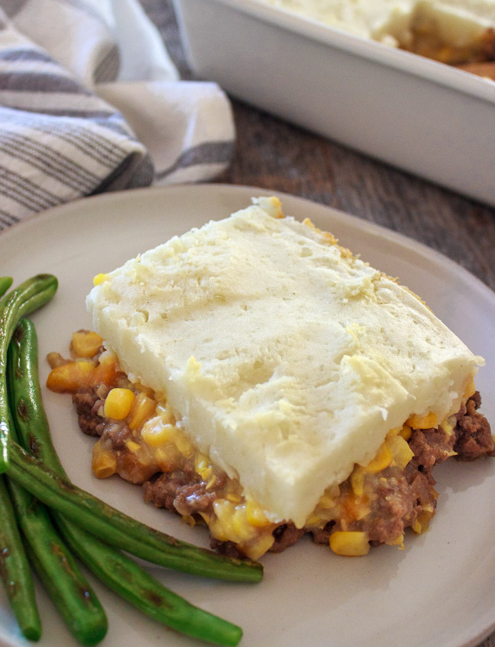 Shepherd's Pie with Ground Beef & Creamed Corn on plate with sauteed green beans