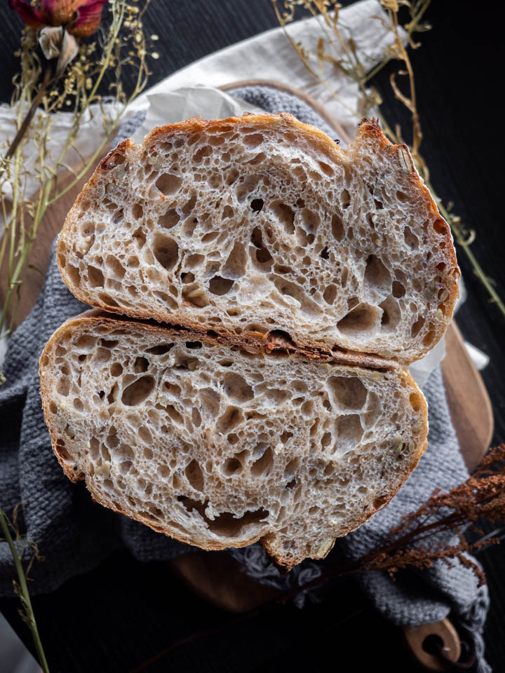A loaf of sourdough cut in half to show the air pockets created by the fermentation process
