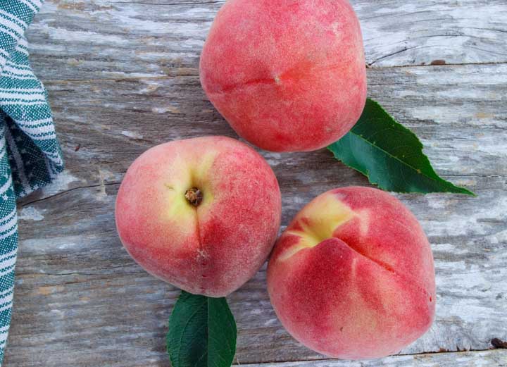 Fresh white peaches showing their red, pink and yellow coloring
