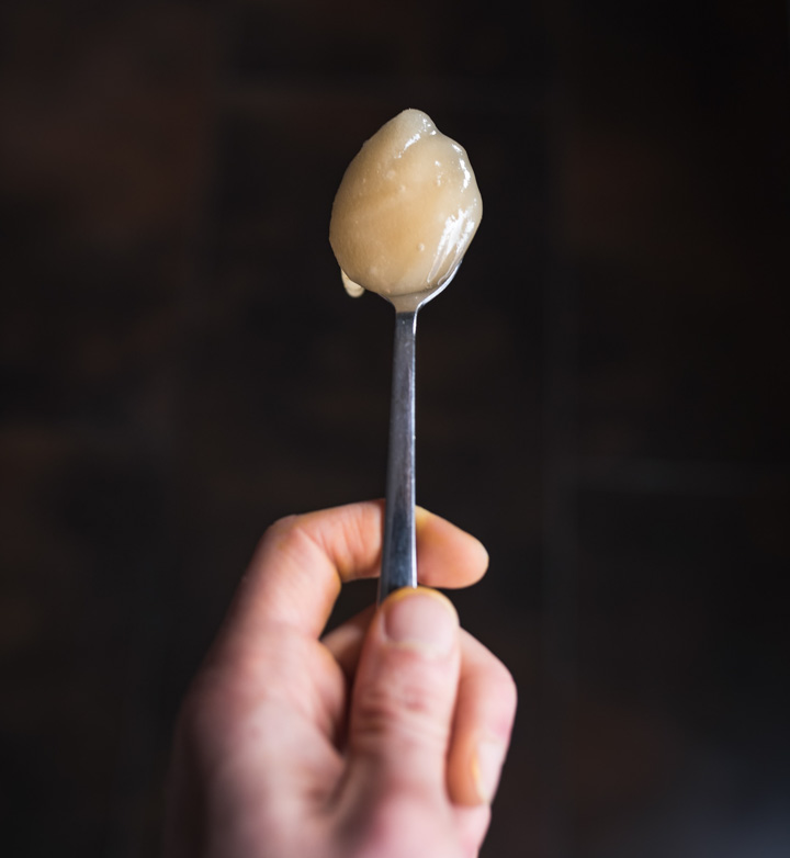 Whipped honey on a spoon. Also known as creamed honey.