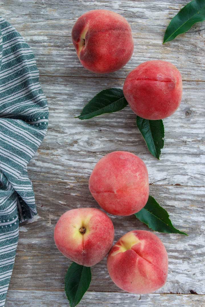 Fresh summer peaches on a picnic table