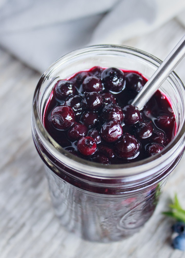 Delicious closeup photo of blueberry sauce in a glass jar