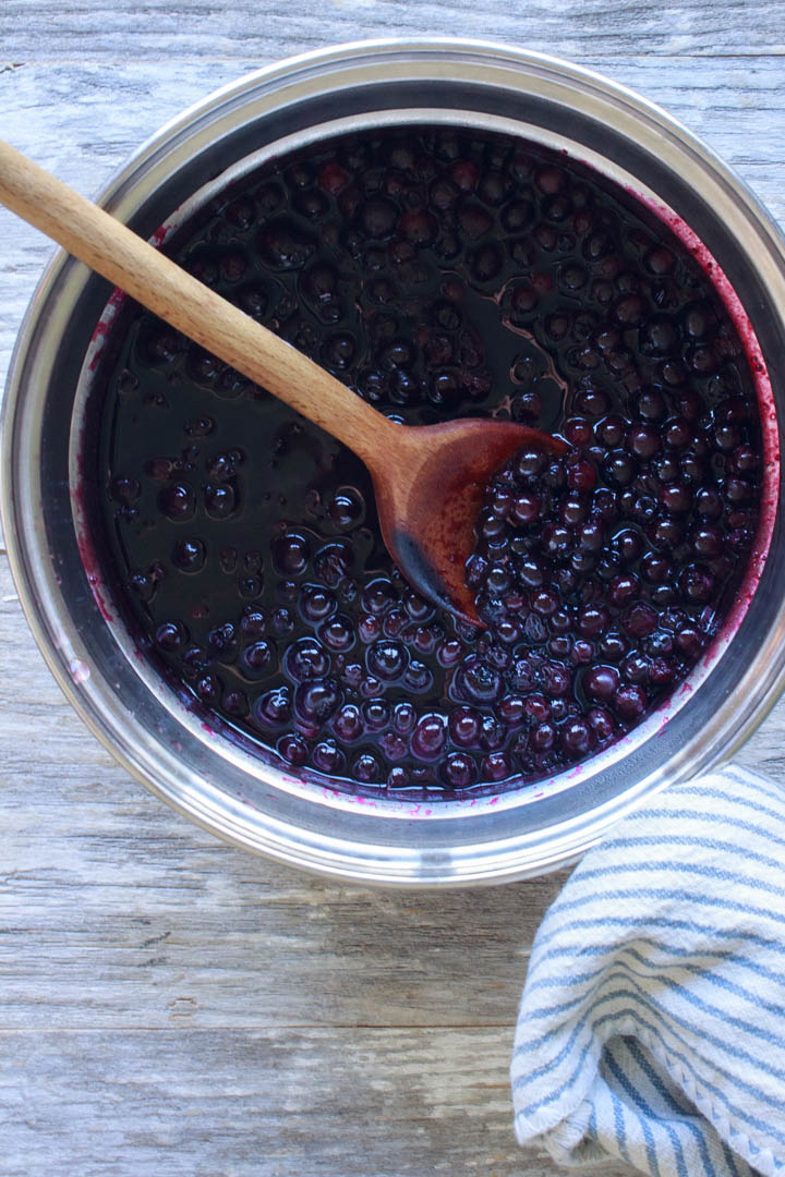 Fresh blueberries simmering to make blueberry sauce.