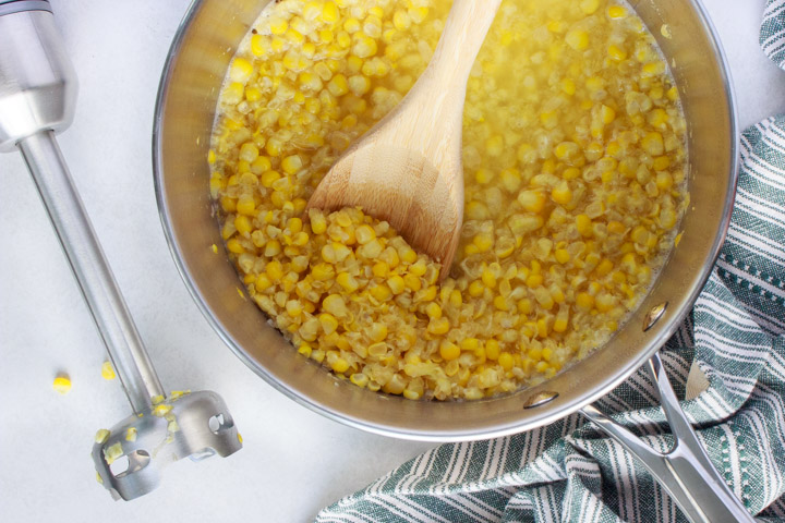 Using an immersion blender to puree cream corn