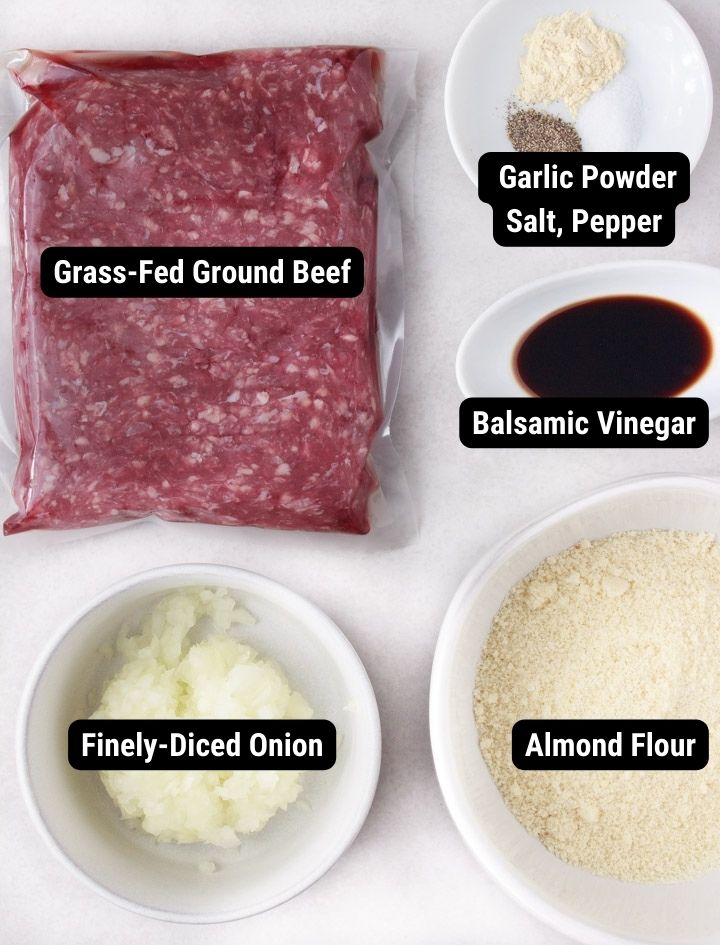 Ingredients to make meatballs without egg: grass-fed ground beef, garlic powder, salt, pepper, balsamic vinegar, almond flour, yellow onion.