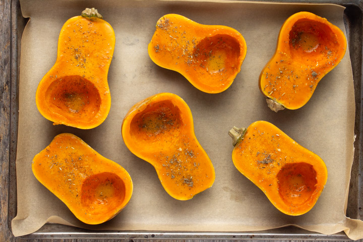 Baking pan with honeynut squash about to go in the oven