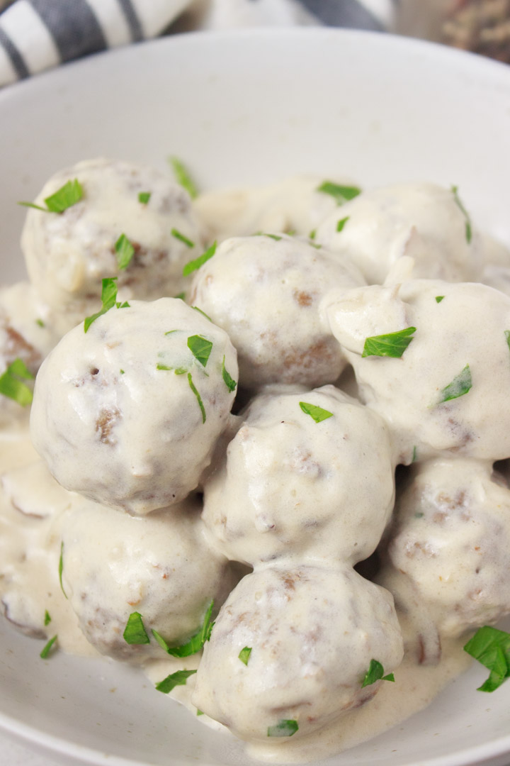 Grass-Fed Beef Meatballs with Creamy Mushroom Sauce and Garlic - Closeup photo of the meatballs in a serving dish