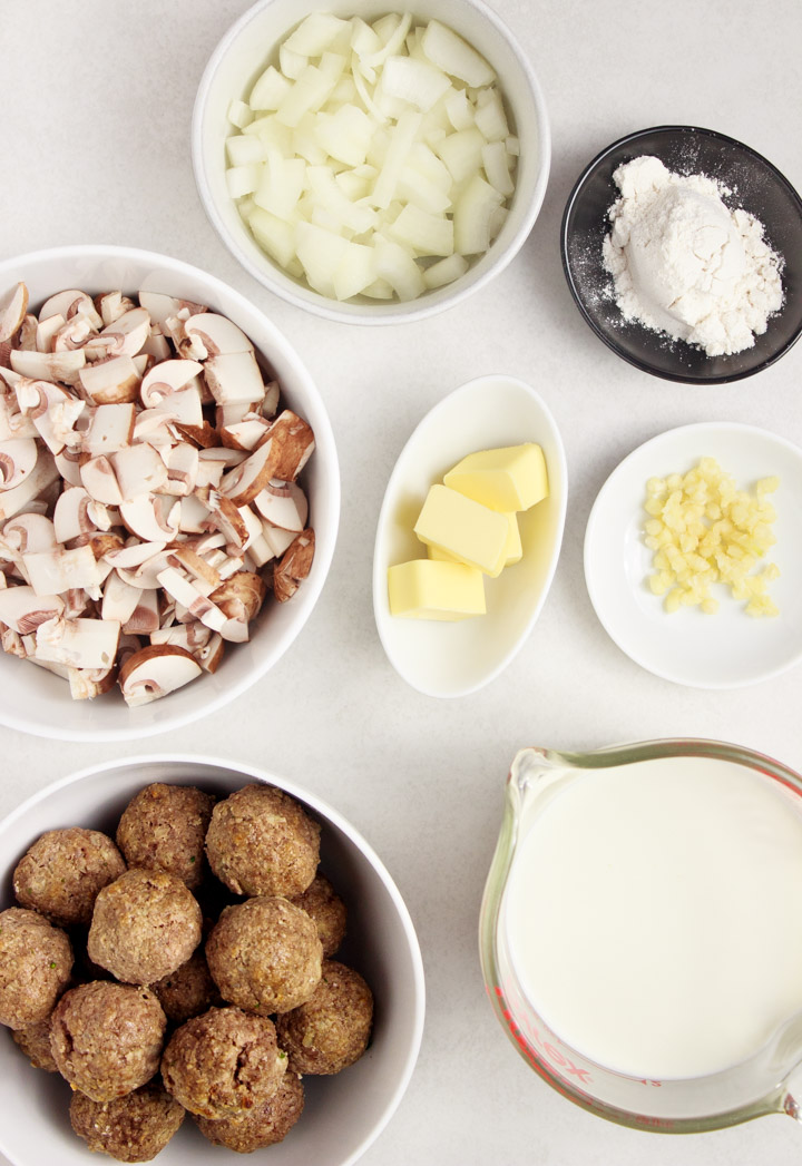 Ingredients to Make Meatballs with Creamy Mushroom Sauce: Sliced mushrooms, baby bella mushrooms, grass-fed beef meatballs, garlic, half and half, butter and gluten-free flour.