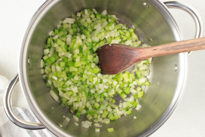 Onion and celery softening in pot to make gluten free dressing
