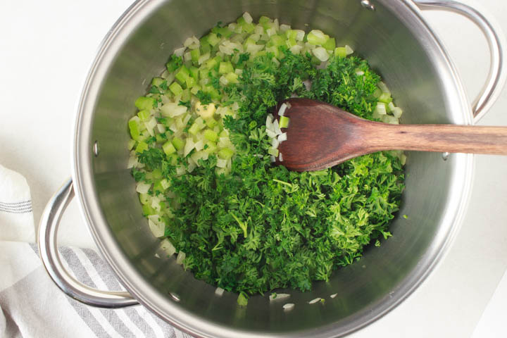 Onion, celery and fresh parsley in pot to make gf dressing